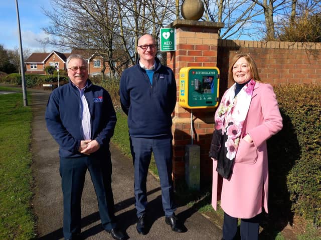 Left right: Bill Shurmer, Councillor Shane Moore and Pam Shurmer with an existing community defibrillator in Merlin Way, Hartlepool.