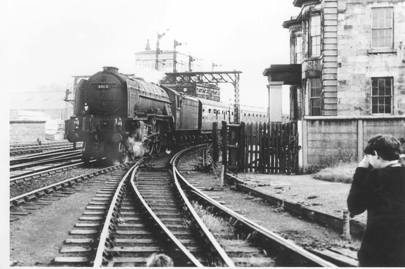 A trainspotter captures the arrival of a steam train as it passes the railway canteen on its approach into Hartlepool railway station in the 1960s.