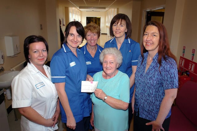 Dorothy Caffey (centre) presents the University Hospital of Hartlepool chemotherapy nurses with a cheque for £200.