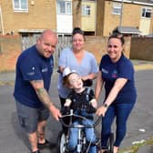 Tilly Grant on her specially adapted trike with Micky Day, Karen Willgress and Kelly Pearson from Miles for Men. Picture by FRANK REID