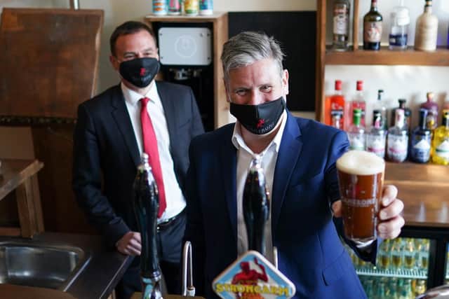 Labour leader Sir Keir Starmer pulled a pint at Camerons brewery, in Hartlepool, during a visit to support by-election candidate Dr Paul Williams, left.
