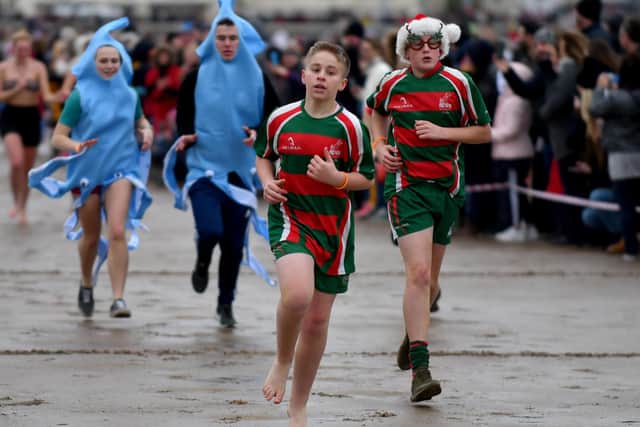 Young dippers race for the sea in 2019's Hartlepool Round Table Boxing Day Dip at Seaton Carew. Picture by FRANK REID