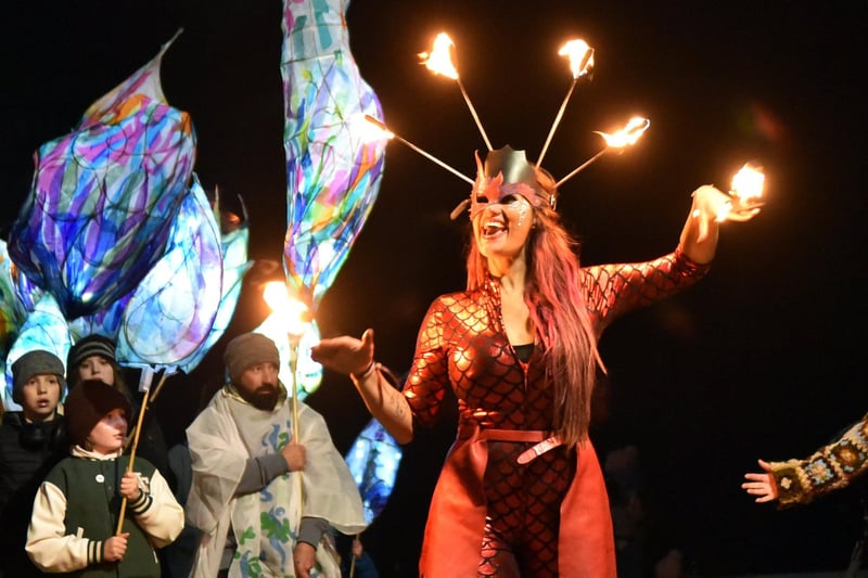 A performer dances with fire at the front of the Wintertide Festival parade as it makes its way around the Headland. Picture by BERNADETTE MALCOLMSON