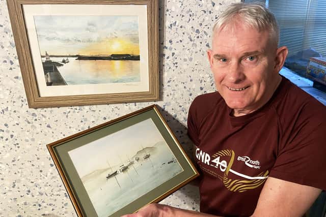 Phil Holbrook with paintings by his late wife Gillian. Picture by FRANK REID.