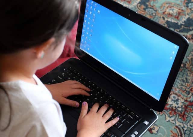 Row flares over schools laptop provision.