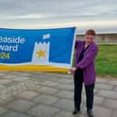 Hartlepool Borough Council quality and safety officer Debbie Kershaw raises the Seaside Award flag at Seaton Carew.