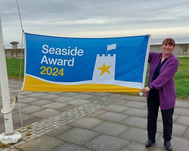 Hartlepool Borough Council quality and safety officer Debbie Kershaw raises the Seaside Award flag at Seaton Carew.