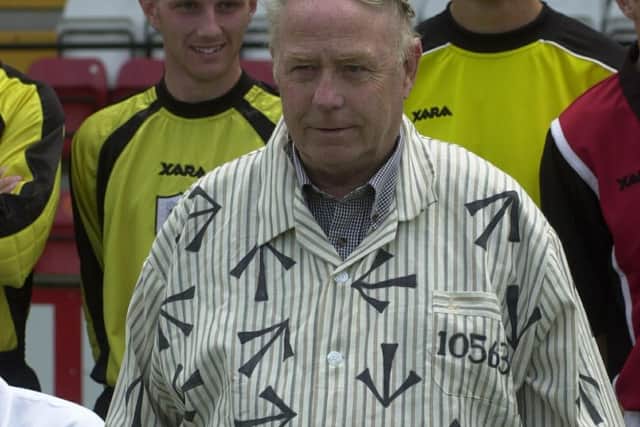 George Reynolds wears a prison outfit for a pre-season team photograph while in charge of Darlington.