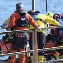 The injured fisherman is stretchered from the all weather lifeboat to an ambulance at the lifeboat station. (Photo: RNLI/Tom Collins)