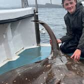 Edward Davies, 15, catches a large common skate whilst on a fishing expedition in Scotland.