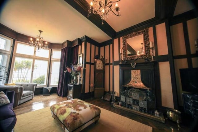 This lounge has an original cast iron fireplace and original wood panelling on the walls.
