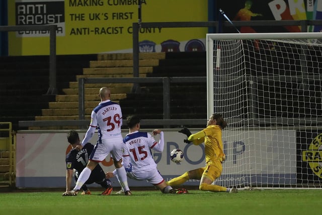 Another roller coaster evening. Erratic at times when palming into trouble and with some of his distribution but also made some fine saves including an excellent stop to deny Guy. (Credit: Mark Fletcher | MI News)