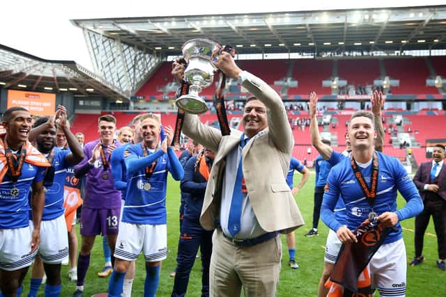 Hartlepool United owner Raj Singh celebrates with the trophy after winning the shoot-out and promotion after the Vanarama National League play-off final at Ashton Gate, Bristol (photo: Nigel French/PA)