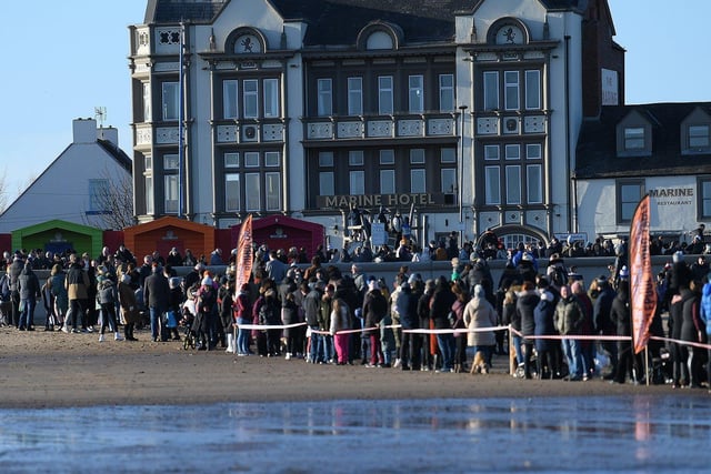 Members of the public line the route down the beach to see the Boxing Day dippers run to the sea. Picture by FRANK REID