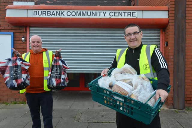 Poolie Time Exchange's Dave Hunter and Stephen Picton, right, with food donations at Burbank Community Centre.