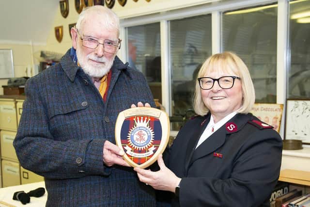 James Gilman presents a replica of the plaque to Major Jane Cowell from the Salvation Army.