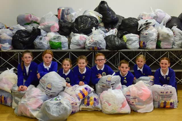 Pupils at Barnard Grove Primary School, in Hartlepool, with bags of clothes donated as part of the school's recycling scheme.