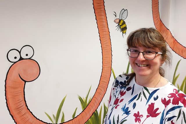 Assistant hub coordinator Sharon Iddon admires the artwork in the new children’s area.