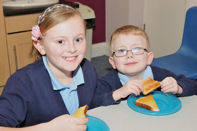 Nicole Gray (11) and Curtis Morfoot (5) enjoying their toast at the breakfast club at Owton Manor Primary School in 2013.