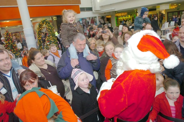 Families greet the arrival of Santa to his grotto in 2008.
