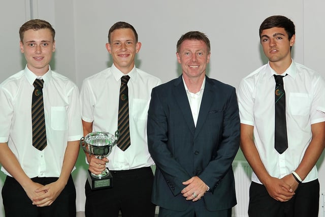 Former professional footballer, Craig Hignett, presents year 11 school pupils with the town cup.