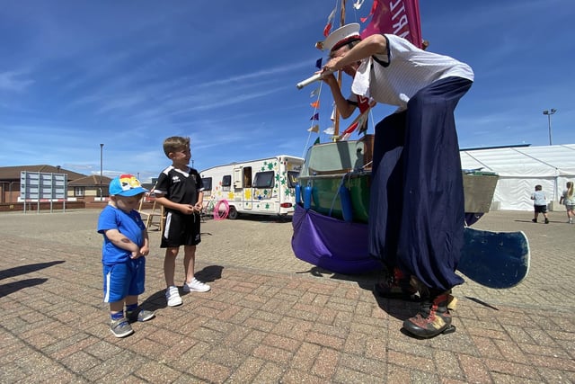 A long-legged sailor welcomes two young visitors to the Waterfront Festival. Picture by FRANK REID