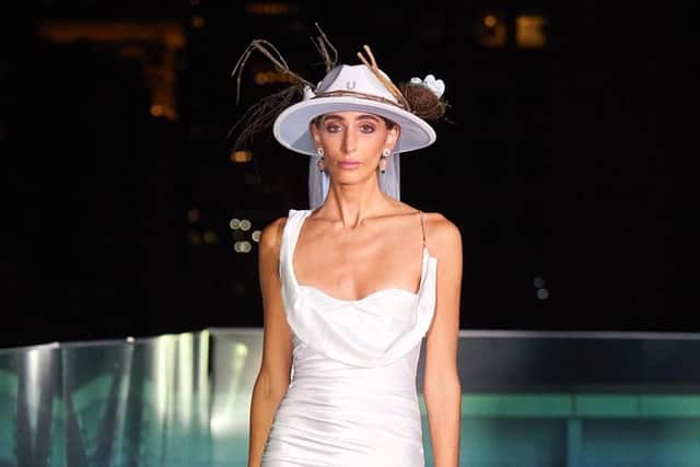 A model shows off one of Lew Elle Bridal's hats during New York Fashion Week 2022.