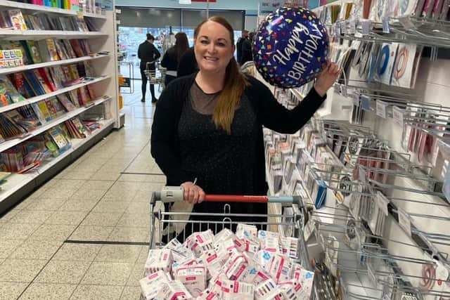 Lyndsay Hogg buying sanitary products to be donated across town./Photo: Lyndsay Hogg