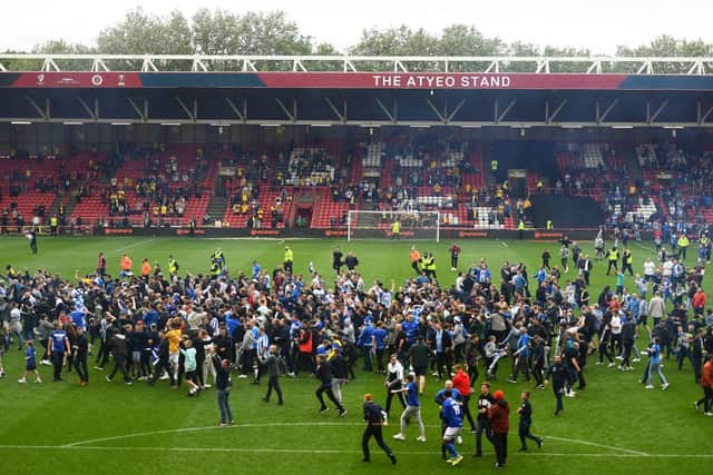Fans of Hartlepool United celebrate on the pitch following the Vanarama National League Play-Off Final match between Hartlepool United and Torquay United at Ashton Gate on June 20, 2021 in Bristol, England. (Photo by Harry Trump/Getty Images)