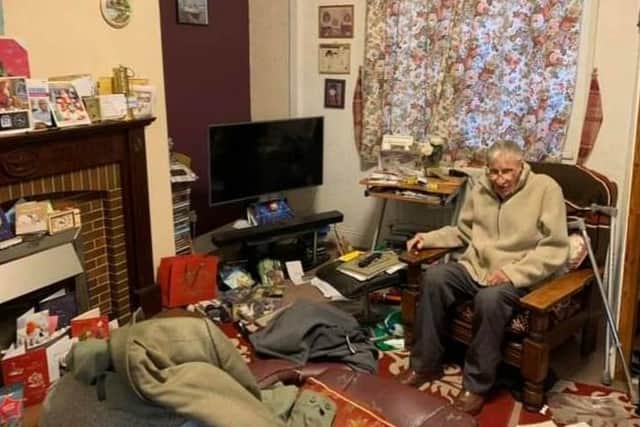 Edwin Green, who is known as Ted to his friends, in the sitting room of his home which was wrecked during a burglary.
