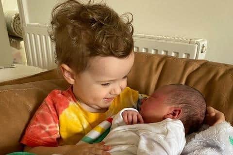 Two-year-old Arthur Dunnett with his new baby brother William.