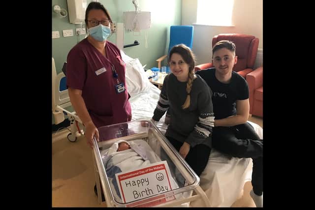 Amy Beattie and Luke Weighill with midwife Jacqueline Lewis and their newborn baby son.