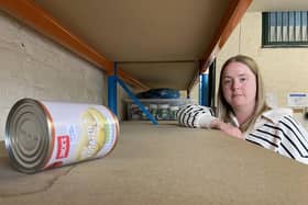 Teagan Burns from the Hartlepool Foodbank next to empty shelving. Picture by FRANK REID