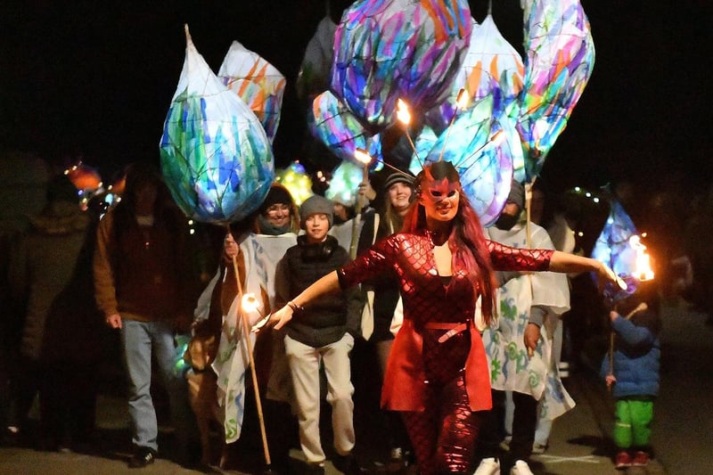 A performer dances with fire at the front of the Wintertide Festival parade as it makes its way around the Headland. Picture by FRANK REID