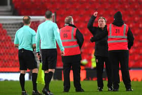 Neil Warnock, manager of Middlesborough is held back by a steward during the Sky Bet Championship match between Stoke City and Middlesbrough at Bet365 Stadium on December 05, 2020 in Stoke on Trent, England. The match will be played without fans, behind closed doors as a Covid-19 precaution. (Photo by Gareth Copley/Getty Images)