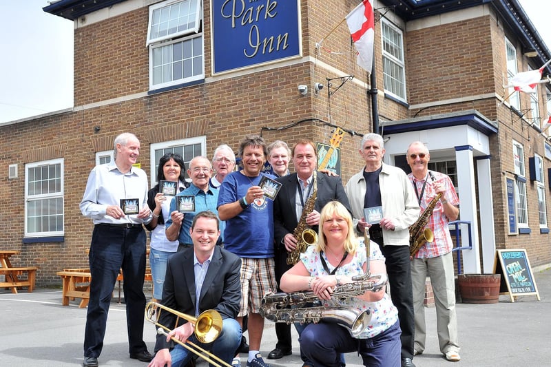 Park Inn tenant Rick Hanlon, centre, and Mick Donnelly with fellow members of Musicians Unlimited celebrate raising £12,000 through their sponsored album in 2012.