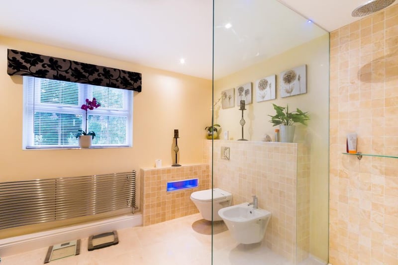 The family bathroom boasts a walk-in shower, a corner bath and double sinks.