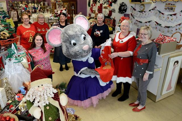 Mascot Alice Mouse gives a helping hand to staff at the Alice House Hospice shop in Middleton Grange as it goes live with its Christmas stock in 2019.