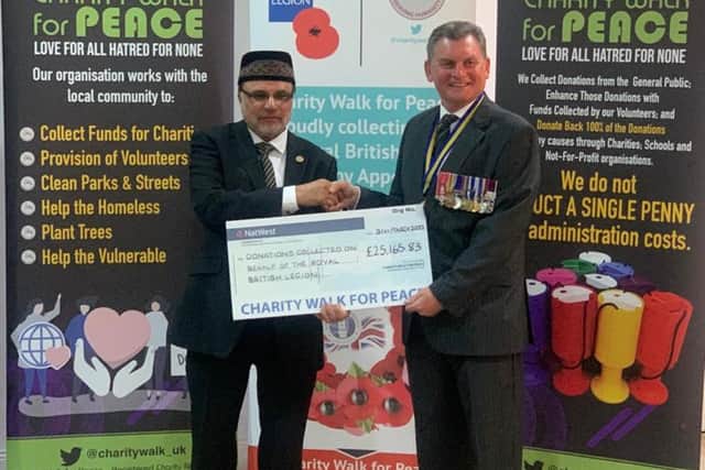 Zaheer Ahmad (left) and Colonel (retired) Ian Simpson MBE of the British Legion Hartlepool Branch with a cheque representing the amount raised for the Poppy Appeal by the Ahmadiyya Muslim Community in the UK.