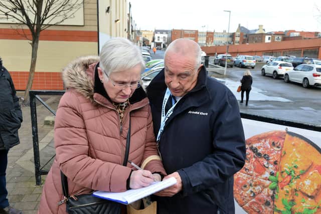 Peter Joyce collects a signature for his joint petition against Hartlepool Borough Council.