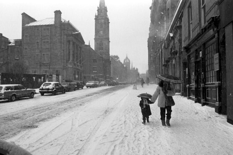 Mother and child walking to school down the High Street when heavy snow hits Edinburgh in January 1987.