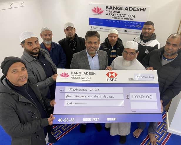 Event organiser, Ahsan Abul (centre), holding a cheque for earthquake victims from the Bangladeshi Cultural Association. Pictured from left: Ashraf Khan, Mohamed Jakaria, Ali Hyder, Maku Mollik, Forruk Ahmed, Habib Ullah, Imthihan Ahmed and Nur Uddin.