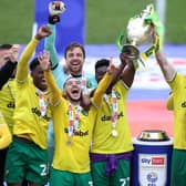Alexander Tettey and Grant Hanley of Norwich City lift the Sky Bet Championship trophy.