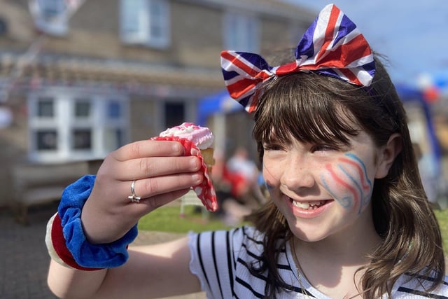 Grace Newcombe can't wait to take a bite of her cake at the Queen's Jubilee celebrations at Mildenhall Close.