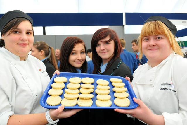 Hartlepool College of FE catering students Danielle Thomas (left) and Charlotte Prosser offer a cake to Dyke House Sports and Technology College pupils Jessica Payne and Ashlyn Pell (centre right) in 2013. Remember this?