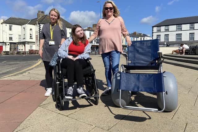 Charlotte Wilson in her wheelchair with one of the volunteers (left) and Counillor Sue Little (right)./Photo: Frank Reid