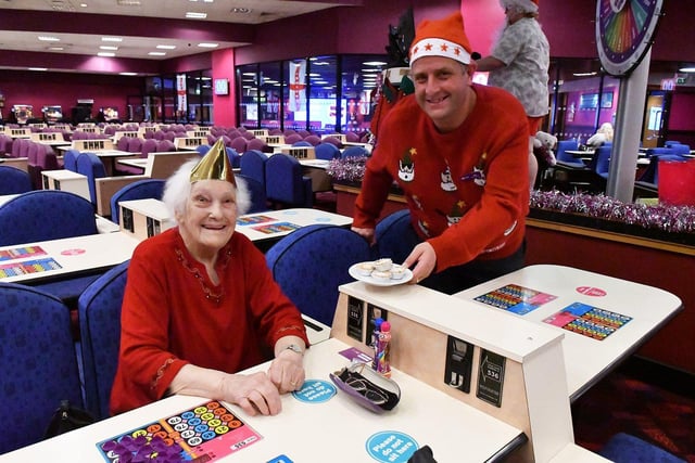 Manager Neil Lamb and customer Rose Samuels celebrate Christmas at Mecca Bingo in 2021.
