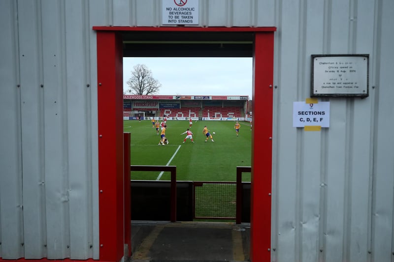 A stolen glance through one of the stadium exits during the FA Cup Third Round match at Cheltenham Town.