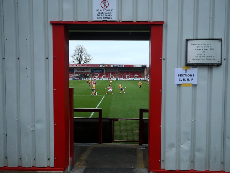 A stolen glance through one of the stadium exits during the FA Cup Third Round match at Cheltenham Town.