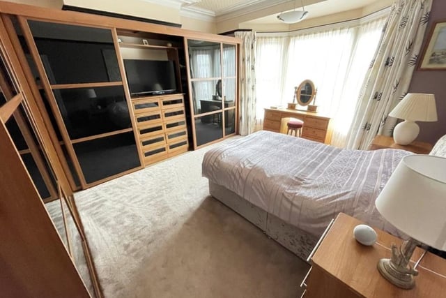 The master bedroom features a range of fitted wardrobes.